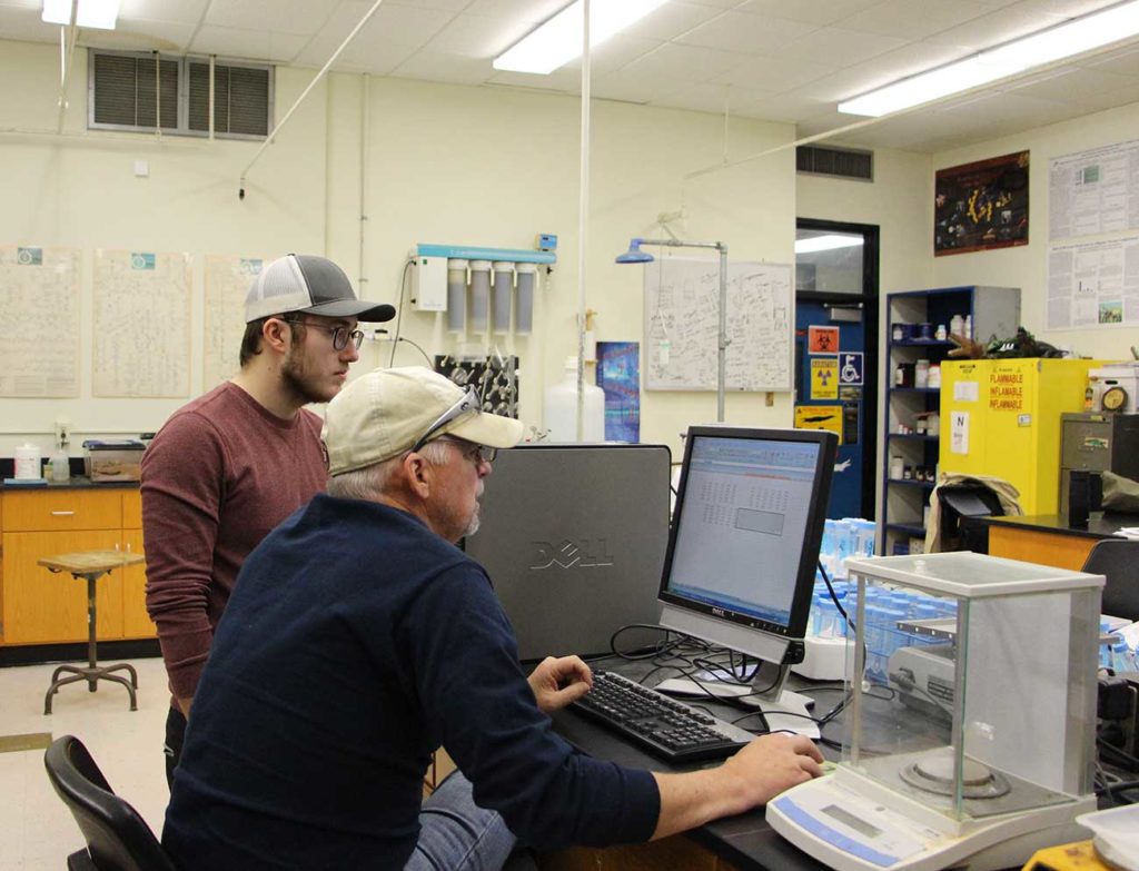 Chemistry junior Seth Aucoin and professor of chemistry Mark Merchant