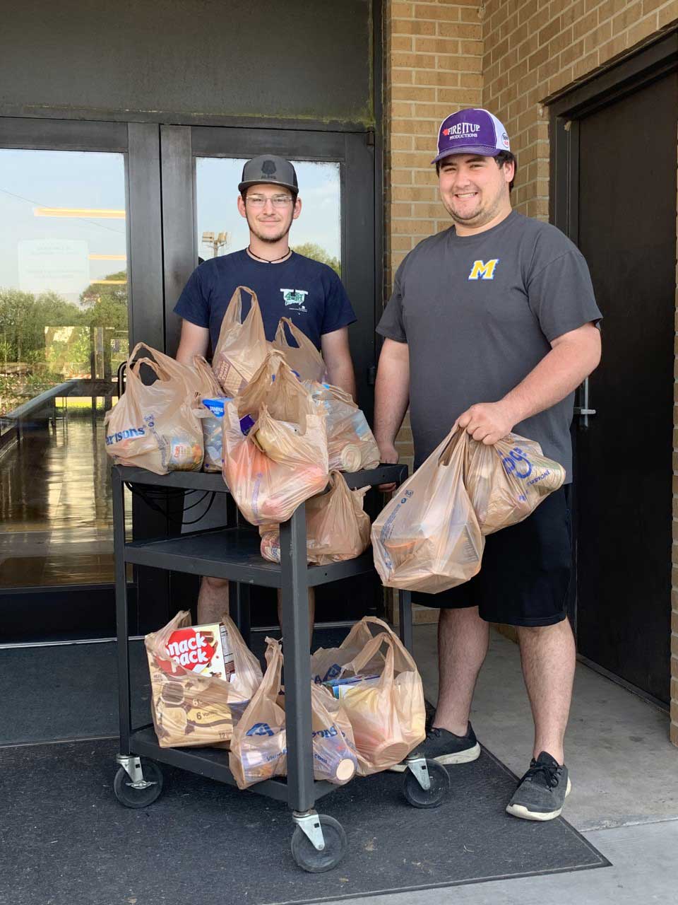 Brennan Uzee and Joshua Lessigne with donations