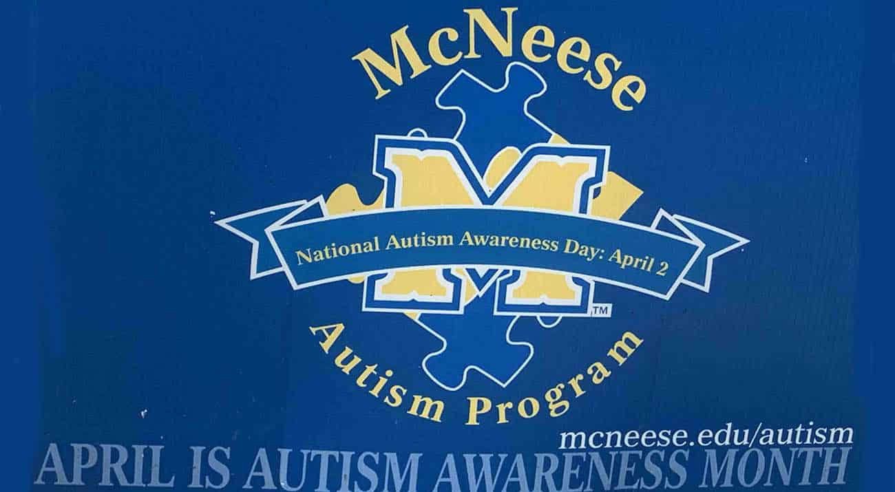 A yard sign with the MAP logo highlights National Autism Month.