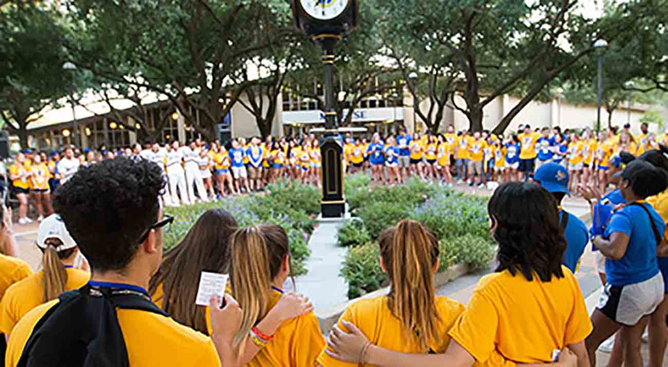 McNeese hosts Cowboy Camp for incoming freshman. Here students gather around the quad clock for 19:39