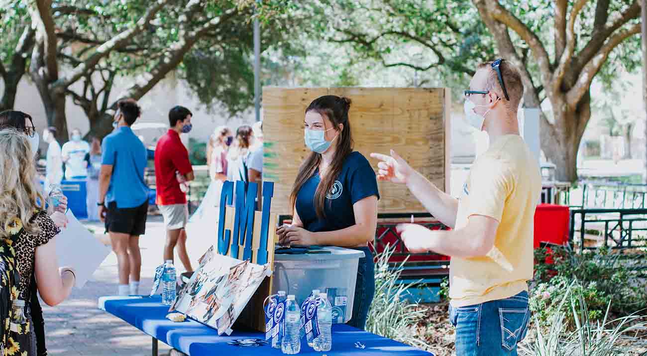 Students walk around the Quad hearing form various university offices and student organizations.