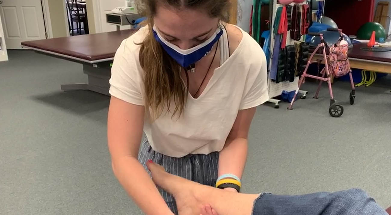 Sadie Zaunbrecher works with patient's foot during physical therapy.