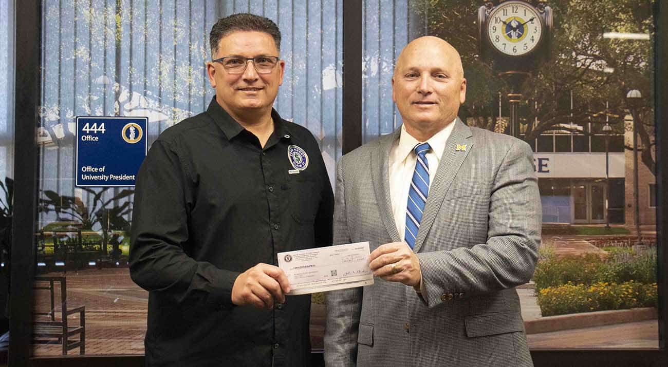 John M. Schroder Sr., Louisiana State Treasurer, presents a check to McNeese President, Dr. Daryl Burckel.