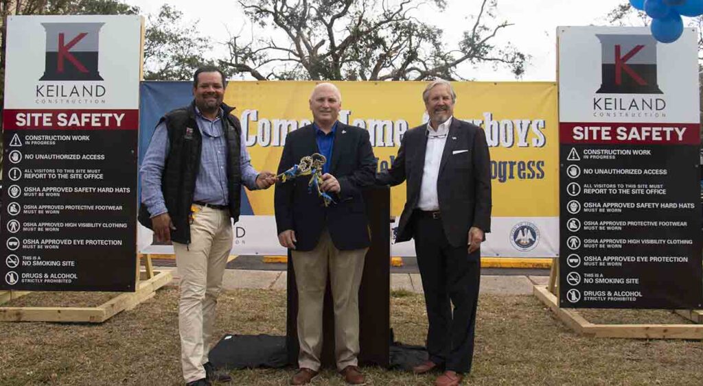 McNeese State University President Dr. Daryl Burckel, center, is presented with keys by Keith DuRousseau, Keiland Contruction president, left, and Buddy Ragland Jr., Coleman Partners Architects LLC owner, as a symbolic celebration of Frasch Hall, Frasch Hall Annex and the Frazar Memorial Library being released back to the university by Keiland Construction.