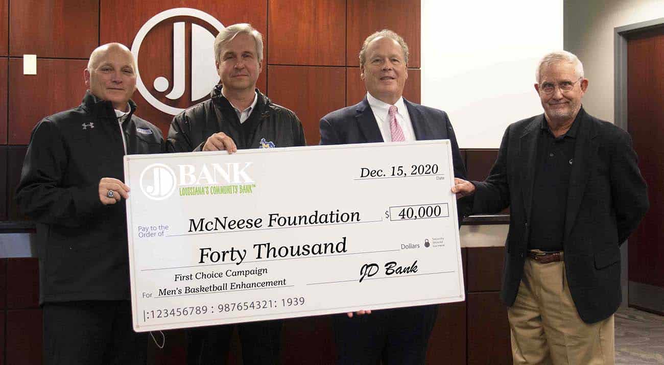 On hand for the presentation are from left, Dr. Daryl Burckel, McNeese president, Dr. Wade Rousse, vice president for university advancement and dean of the college of business, Bruce Elder, JD Bank president and CEO, and Dan L. Donald Jr., chairman of the board.