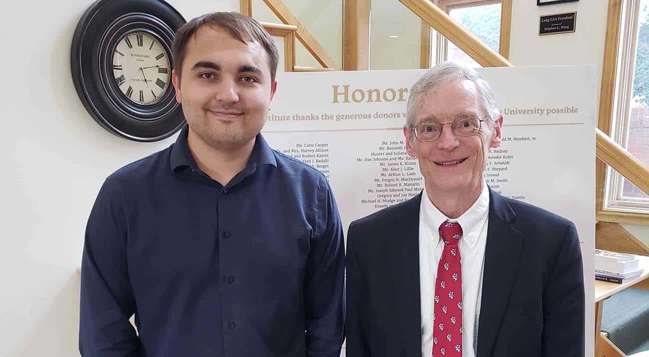 Recent McNeese graduate Devin Cooper, left, and Dr. Jeffrey Herbener, Economics Department Chair at Grove City College, at the Mises University program.