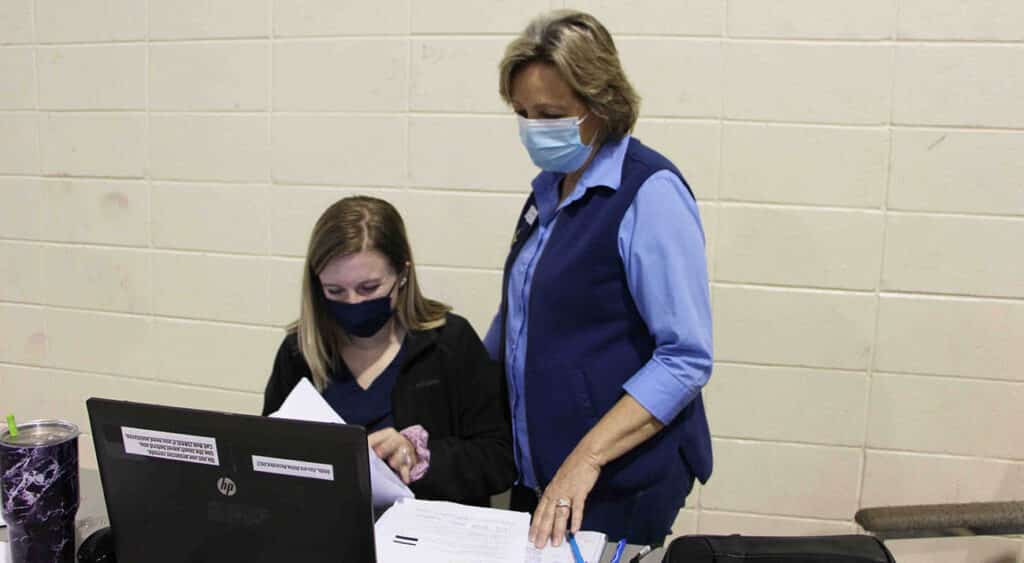 Jassmine Sims, seated, a senior health systems management major, reviews client information with Dr. Amy Bufford, Coordinator of the Health Systems Management Program.