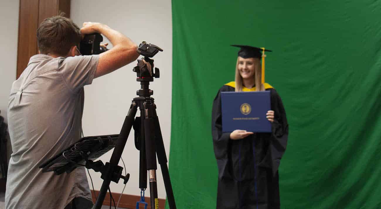 A masters degree student has her photo taken at gradfest.