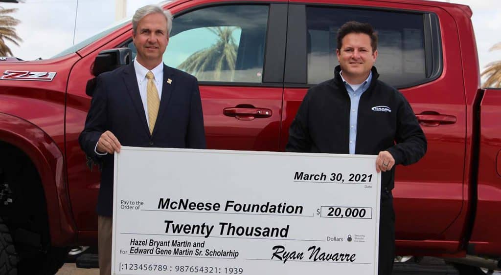 On hand for the donation are, from left, Dr. Wade Rousse, vice president for university advancement and dean of the college of business, and Ryan Navarre, dealer for Navarre Automotive.