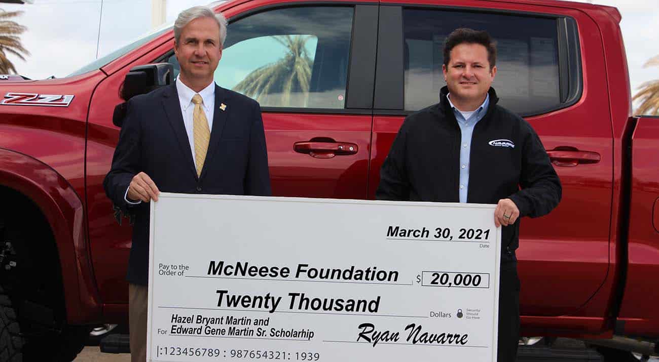 On hand for the donation are, from left, Dr. Wade Rousse, vice president for university advancement and dean of the college of business, and Ryan Navarre, dealer for Navarre Automotive.