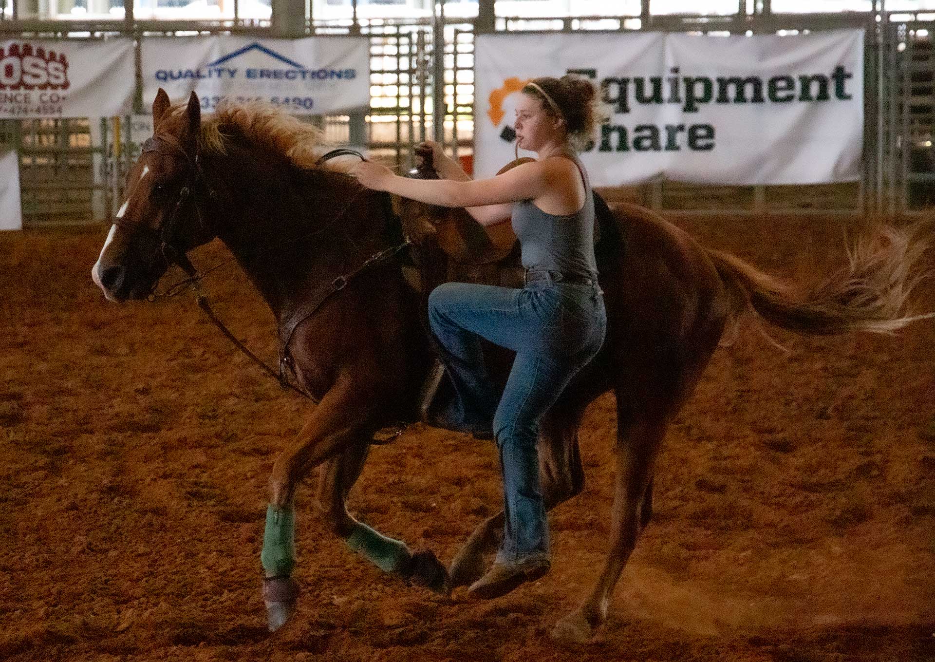 McNeese cowgirl dismounts horse during practice