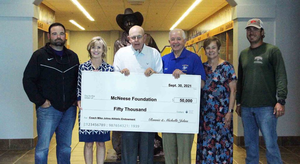 On hand for the presentation are, from left, Mike’s son, Tommy (’05, ’12), Mike’s wife, Barbara (’00), Mike, Ronnie and Michelle, and Mike’s son, Bobby (’11). Not pictured are Bobby’s wife, Dixie, and their daughters Ella, Caroline and Abigail. McNeese Photo