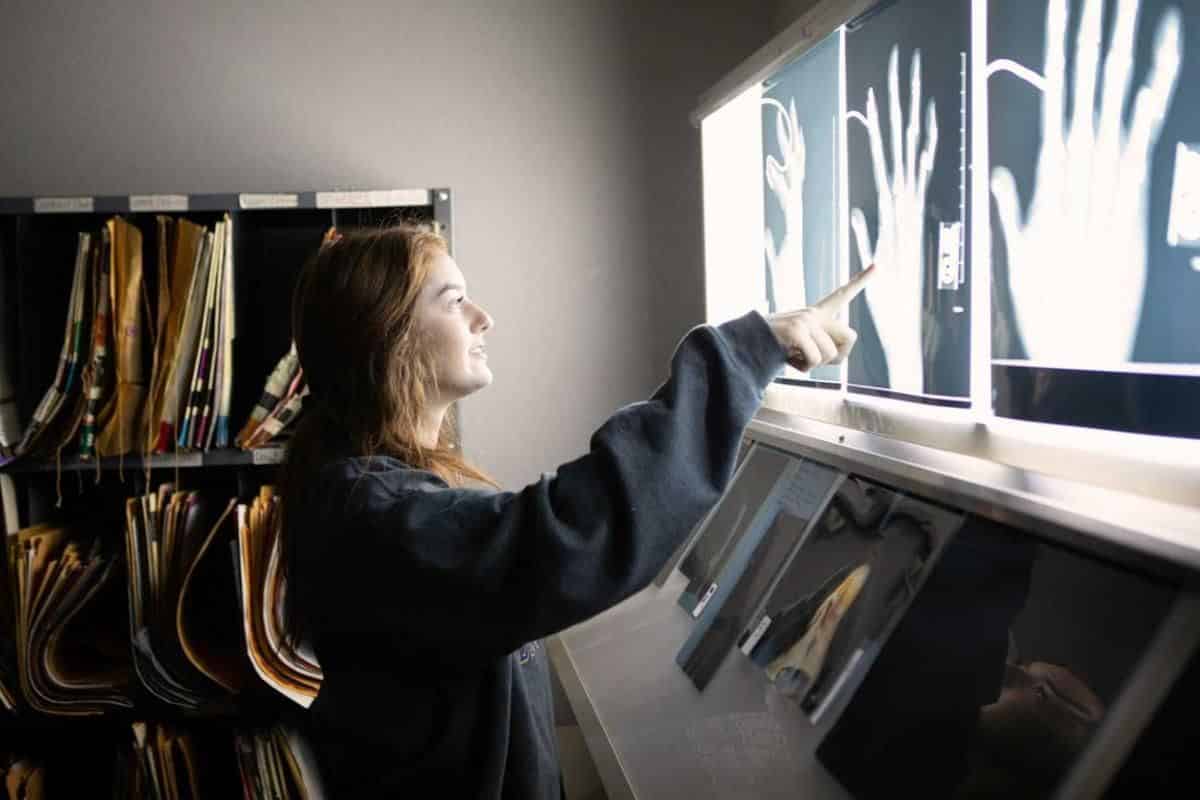 A radiologic sciences student points to an x-ray image