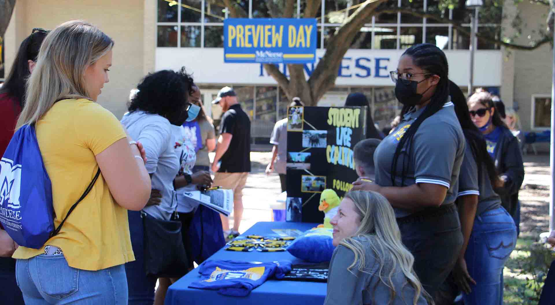 A prospective student talks to a group of Student Life Coalition members.