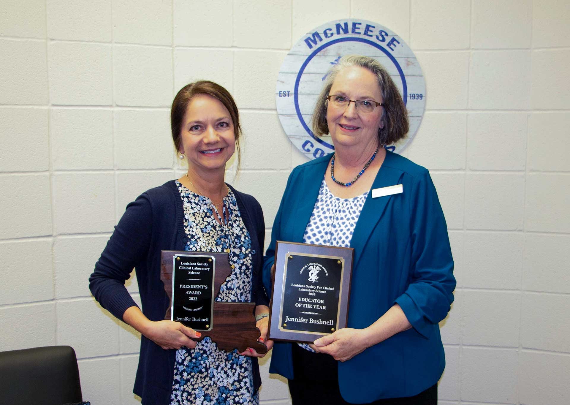 Jennifer Bushnell and Dr. Ann Warner, Dean of College of Nursing and Health Professions, holding two of Bushnell's recent awards