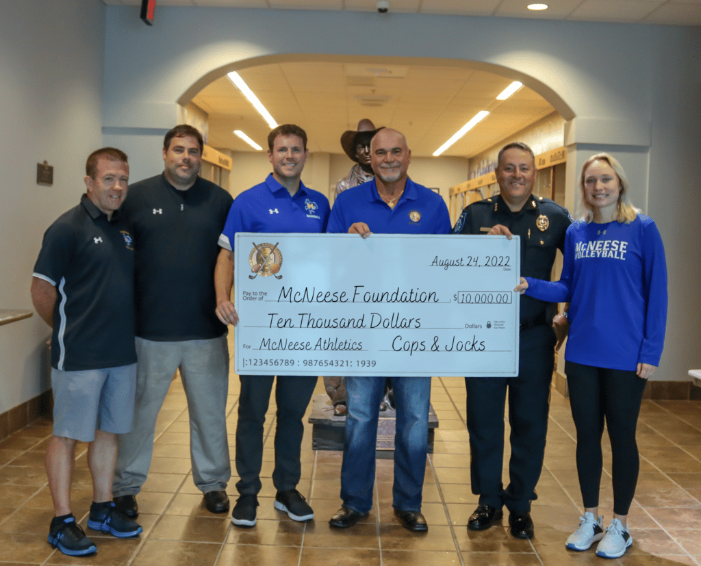 McNeese representatives accepting a donation.