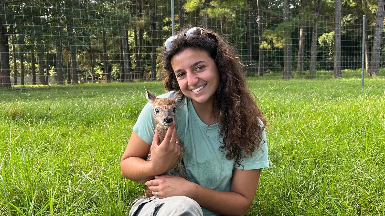 McNeese State University student interns at deer facility.