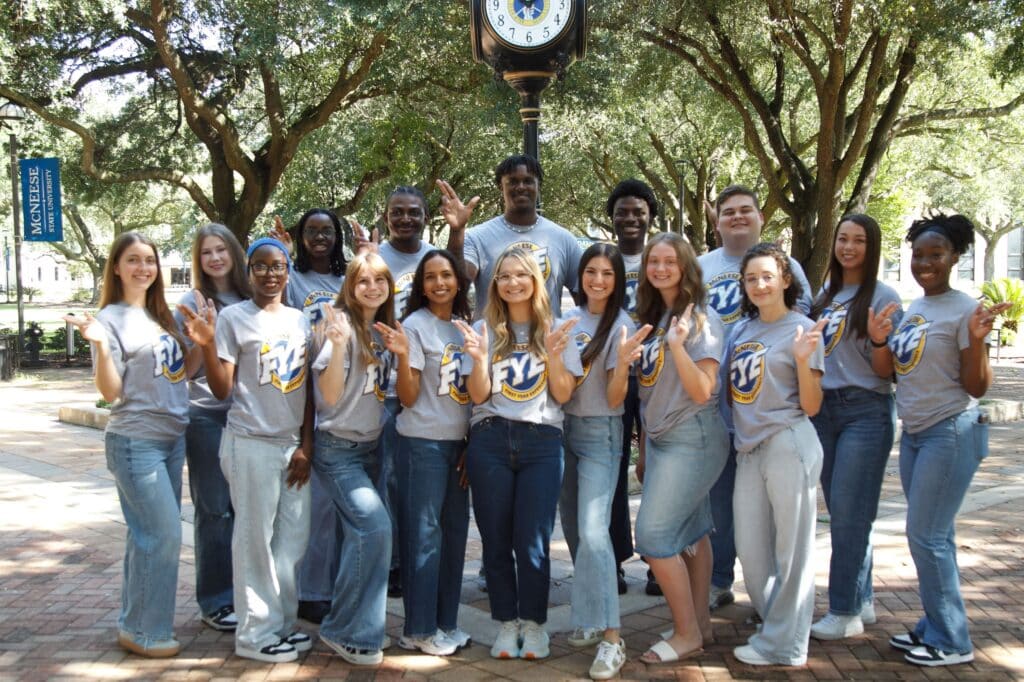 Group photo of FYE mentors doing the "Geaux Pokes" hand sign