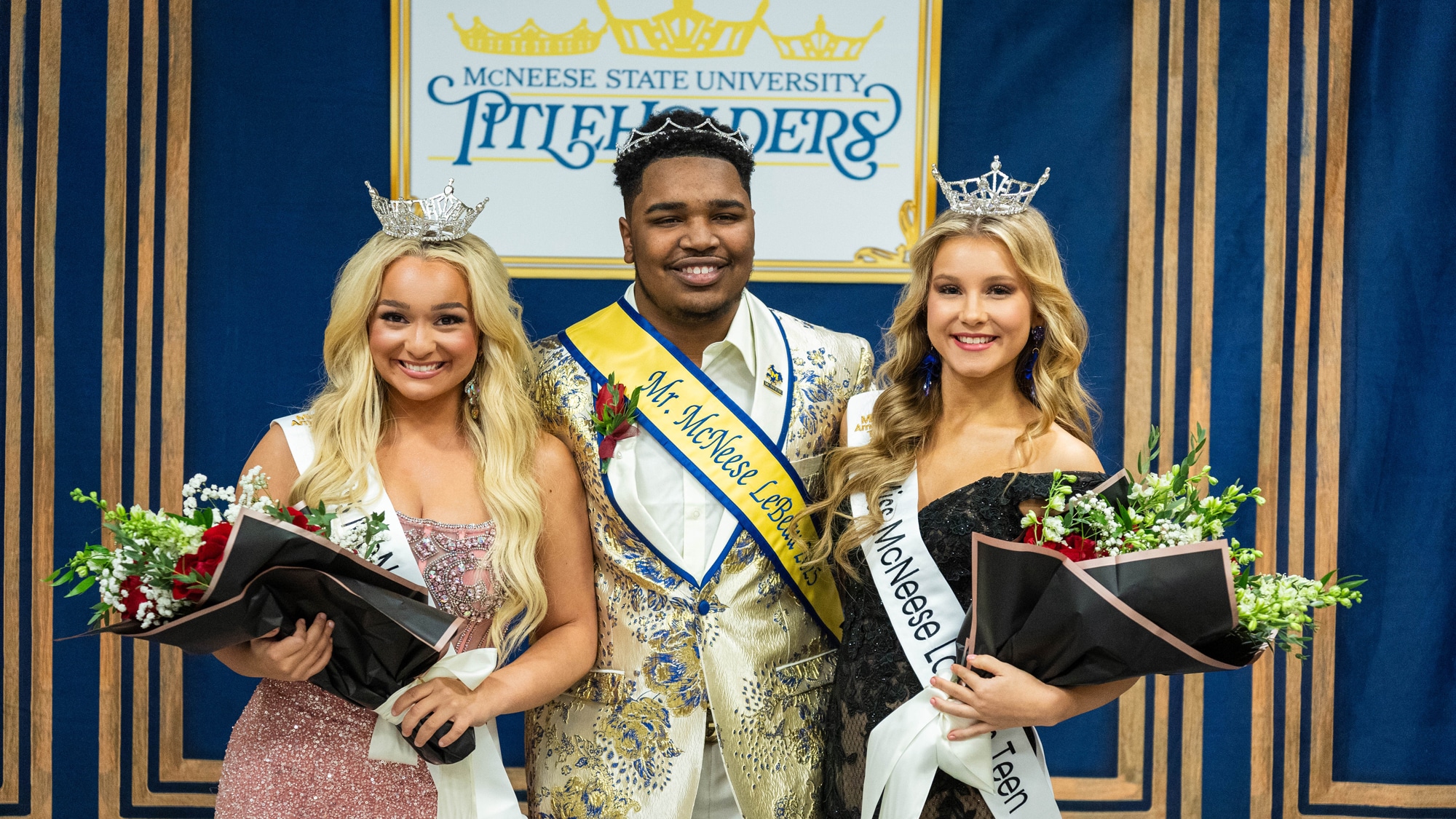 Mr. and Miss McNeese winners pose with sashes and crowns at McNeese State University event, holding bouquet flowers.