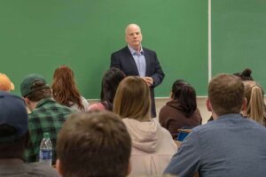 B.J. Hebert addresses the classroom full of students