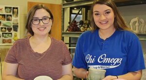 Shelby Roberie and Madison Augustine are pictured with some of their ceramic artwork.