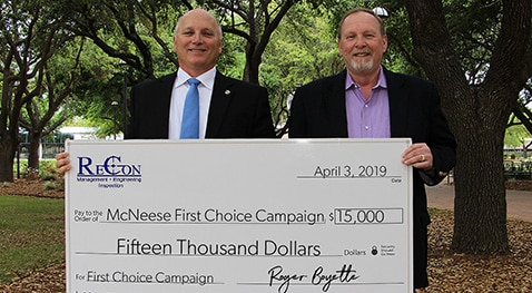 Two men holding a $15,000 check for McNeese First Choice Campaign, issued by ReCon Engineering, April 3, 2019.