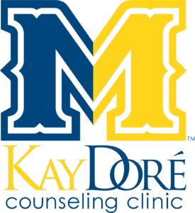 Kay Doré Counseling Clinic logo with blue and yellow letter M