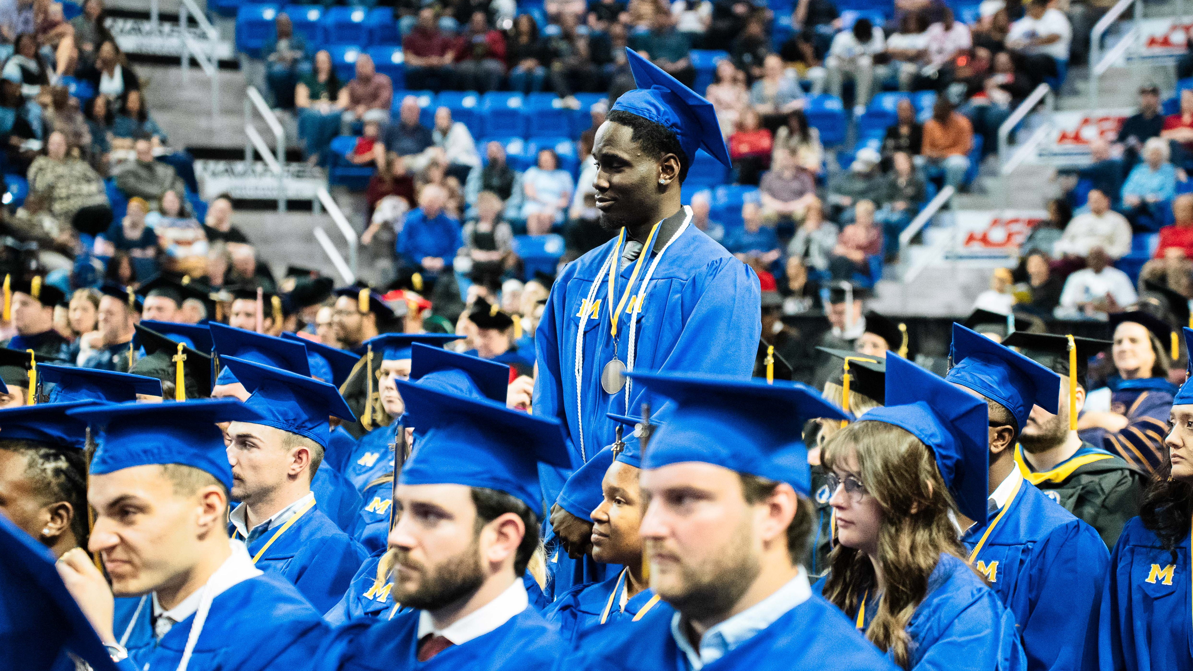 McNeese State University graduates with one standing up as one of the recognized honor graduates.