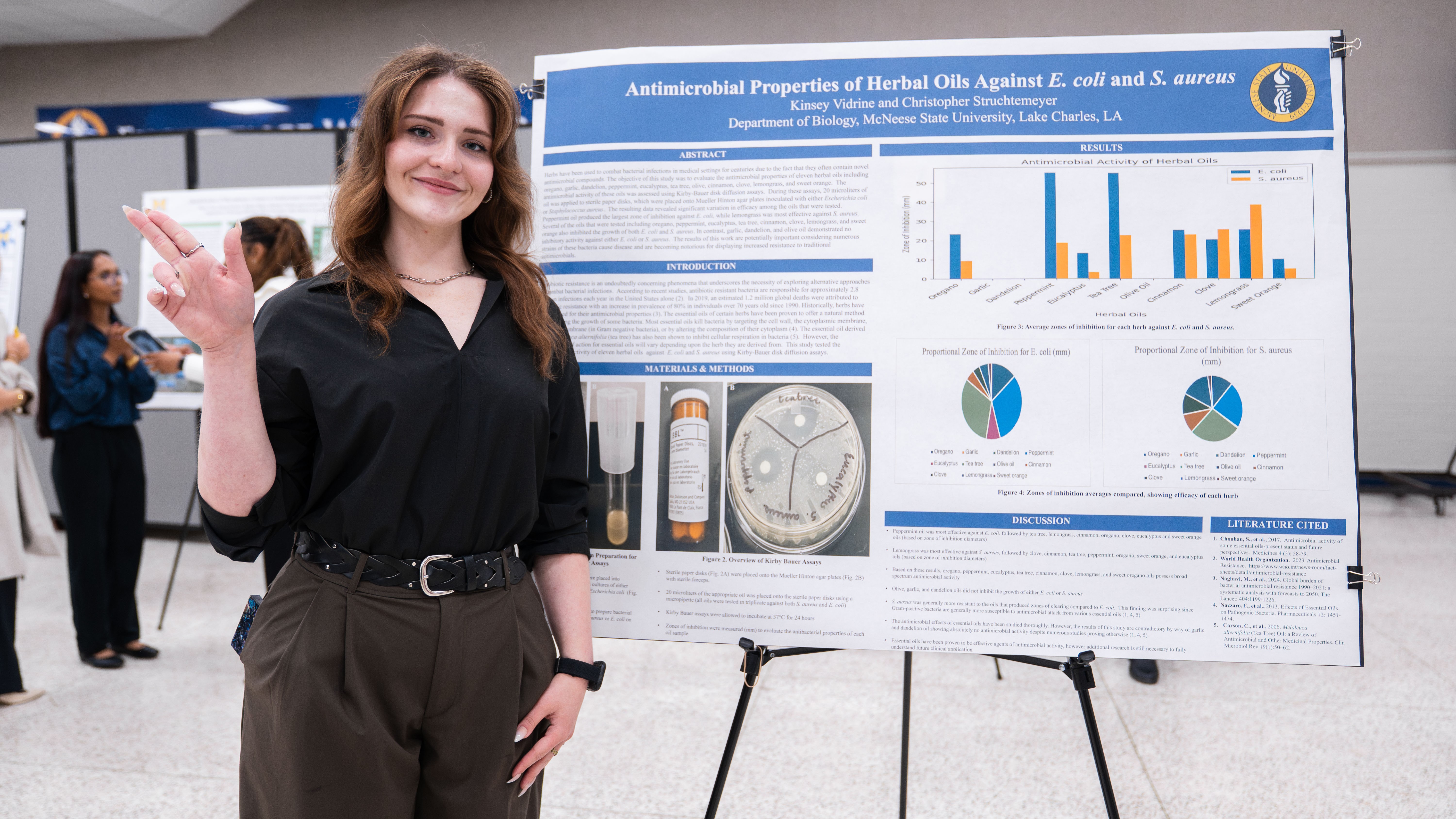 McNeese State University student, Kinsey Vidrine, stands next to her research poster.