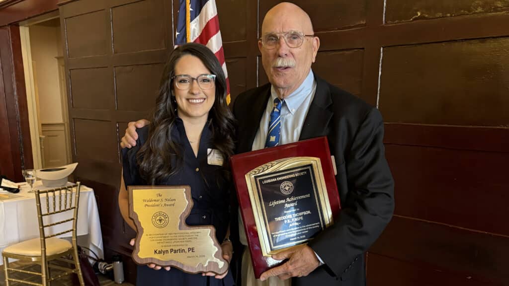 McNeese alumna Kalyn Partin and McNeese faculty member Ted Thompson stand with smiles and their awards.