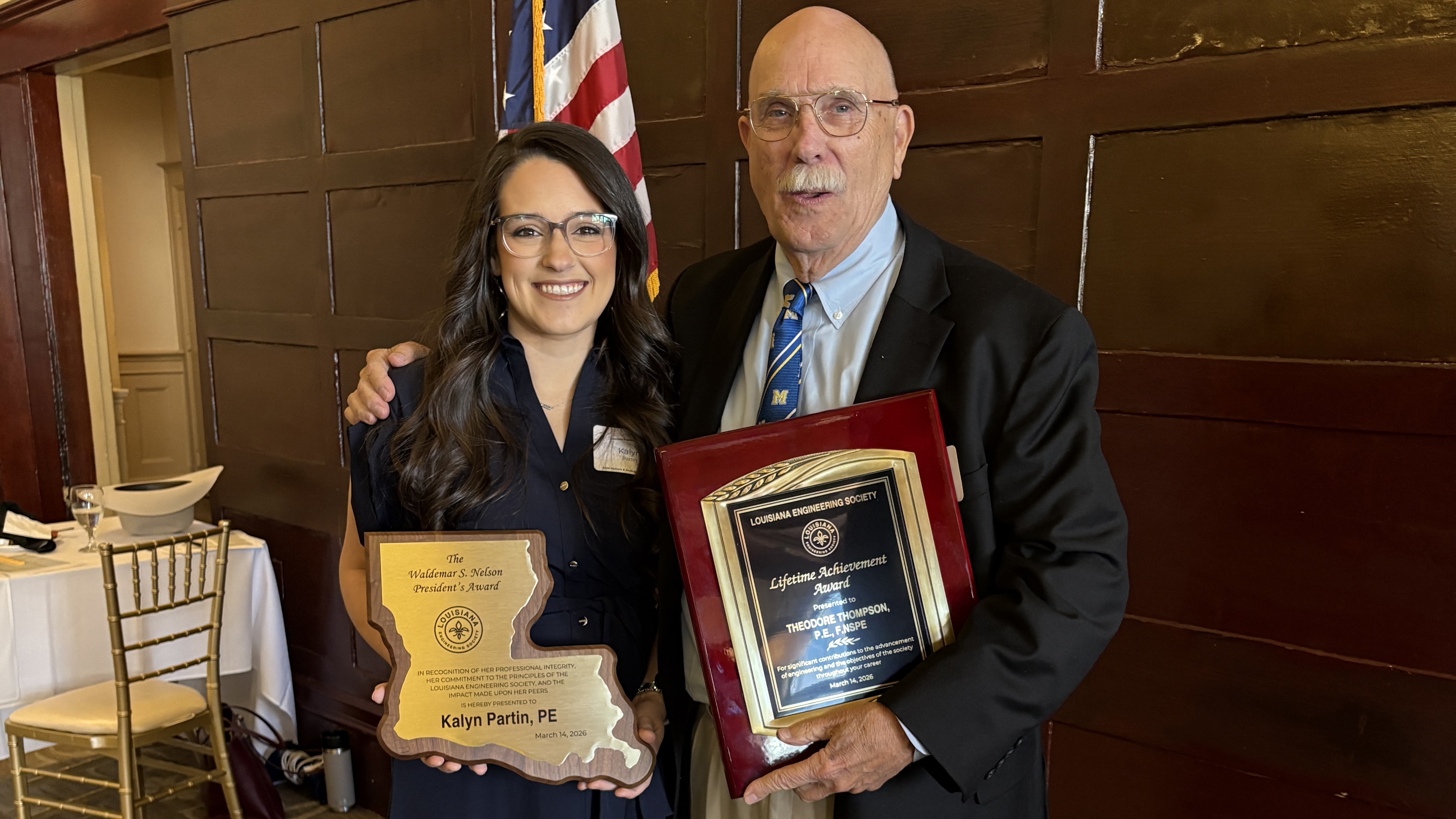 McNeese alumna Kalyn Partin and McNeese faculty member Ted Thompson stand with smiles and their awards.