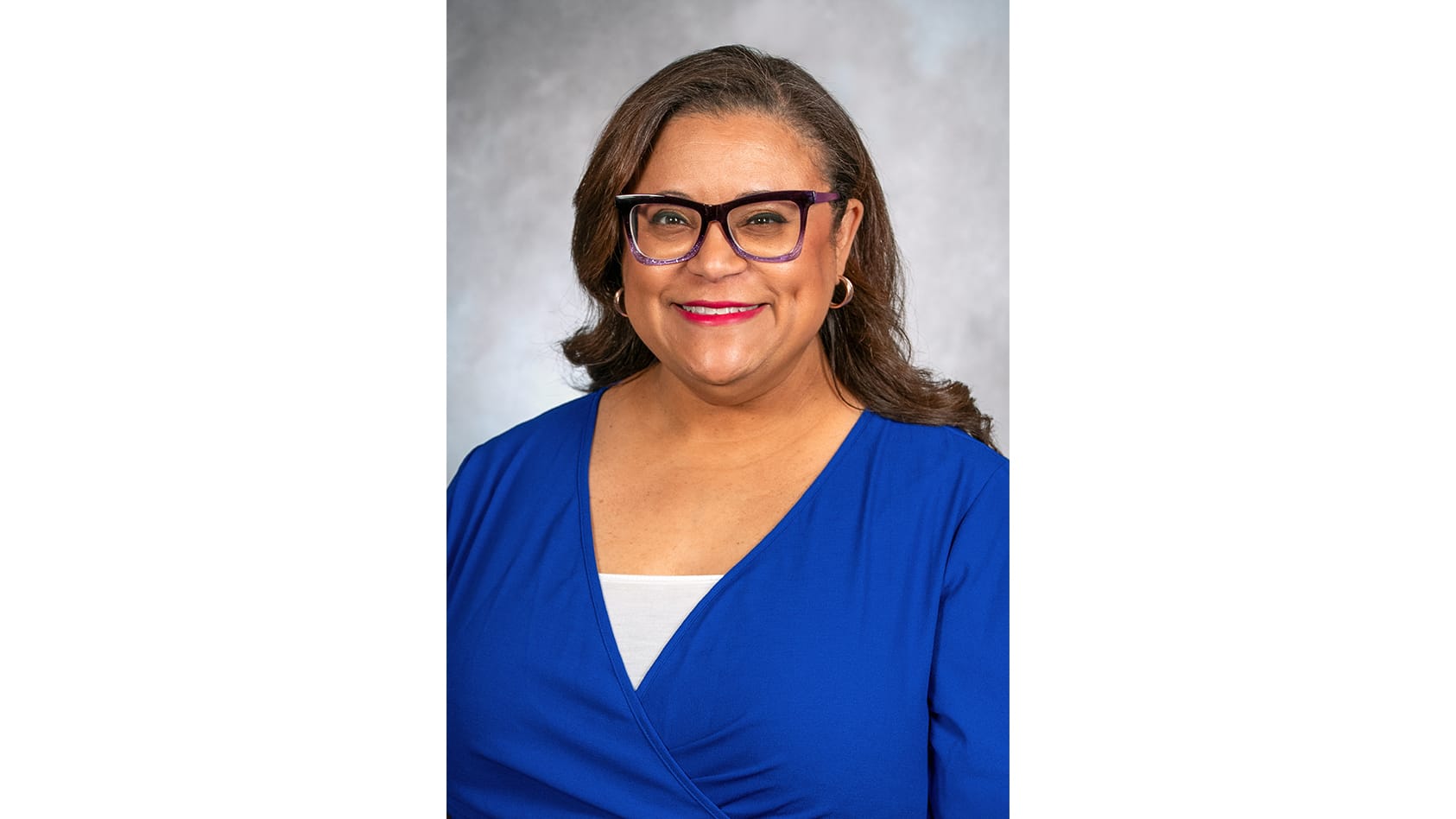 A headshot of Dr. Monica Orsot wearing blue and white.