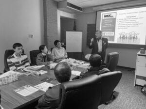 Business meeting with speaker presenting on leadership and team development.